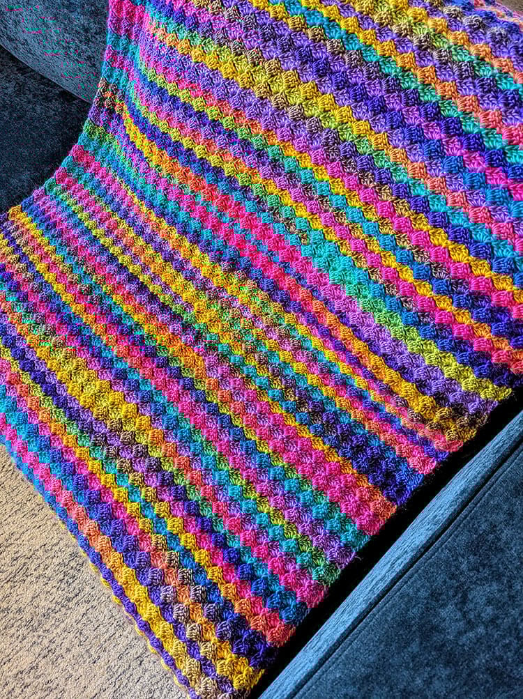 Blooming Hues Crochet Blanket Pattern on Couch