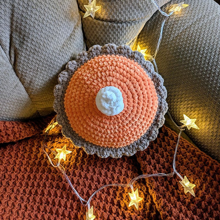 crochet pumpkin pie pillow on chair